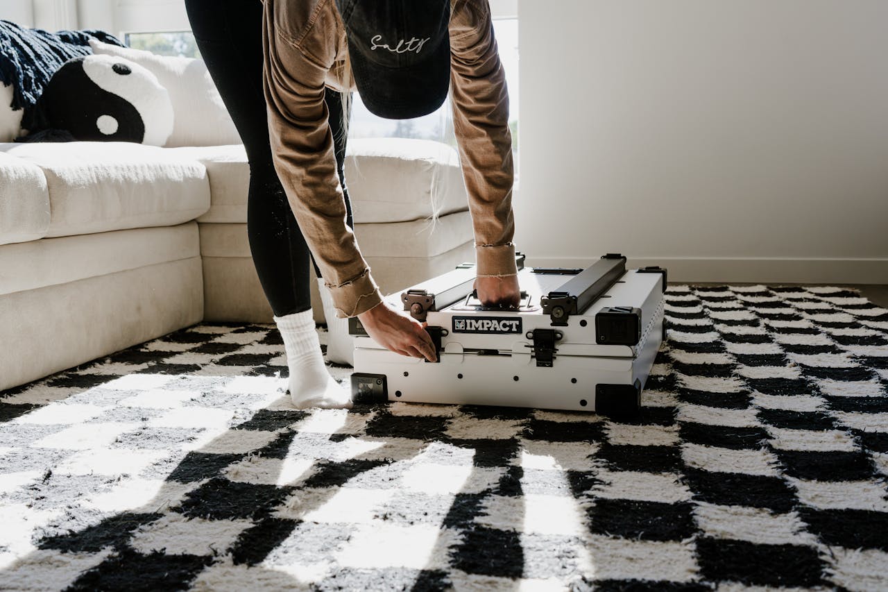 A woman sets up a durable dog crate in a sunlit living room with stylish interiors.